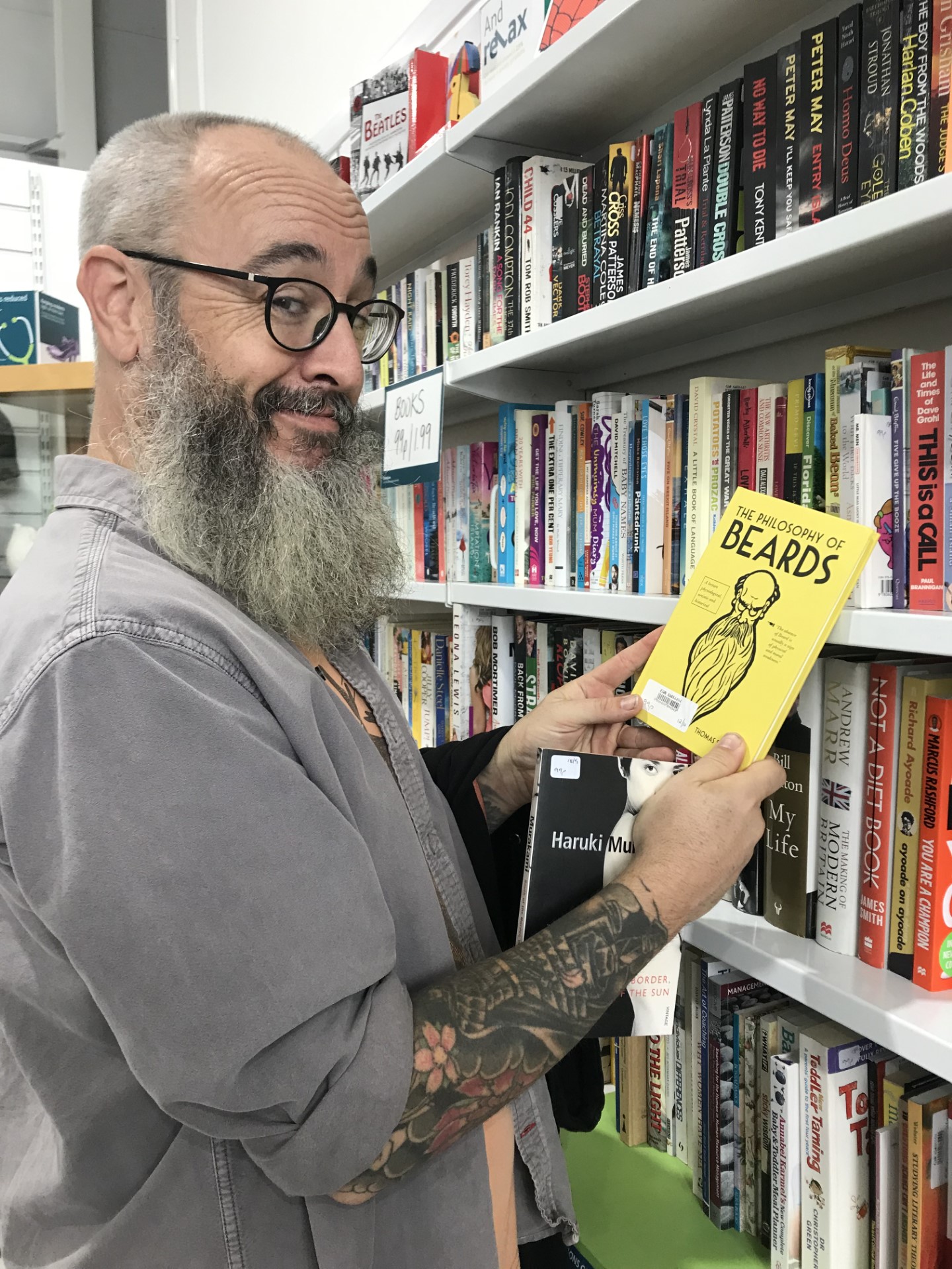 Bearded shopper with a book about beards