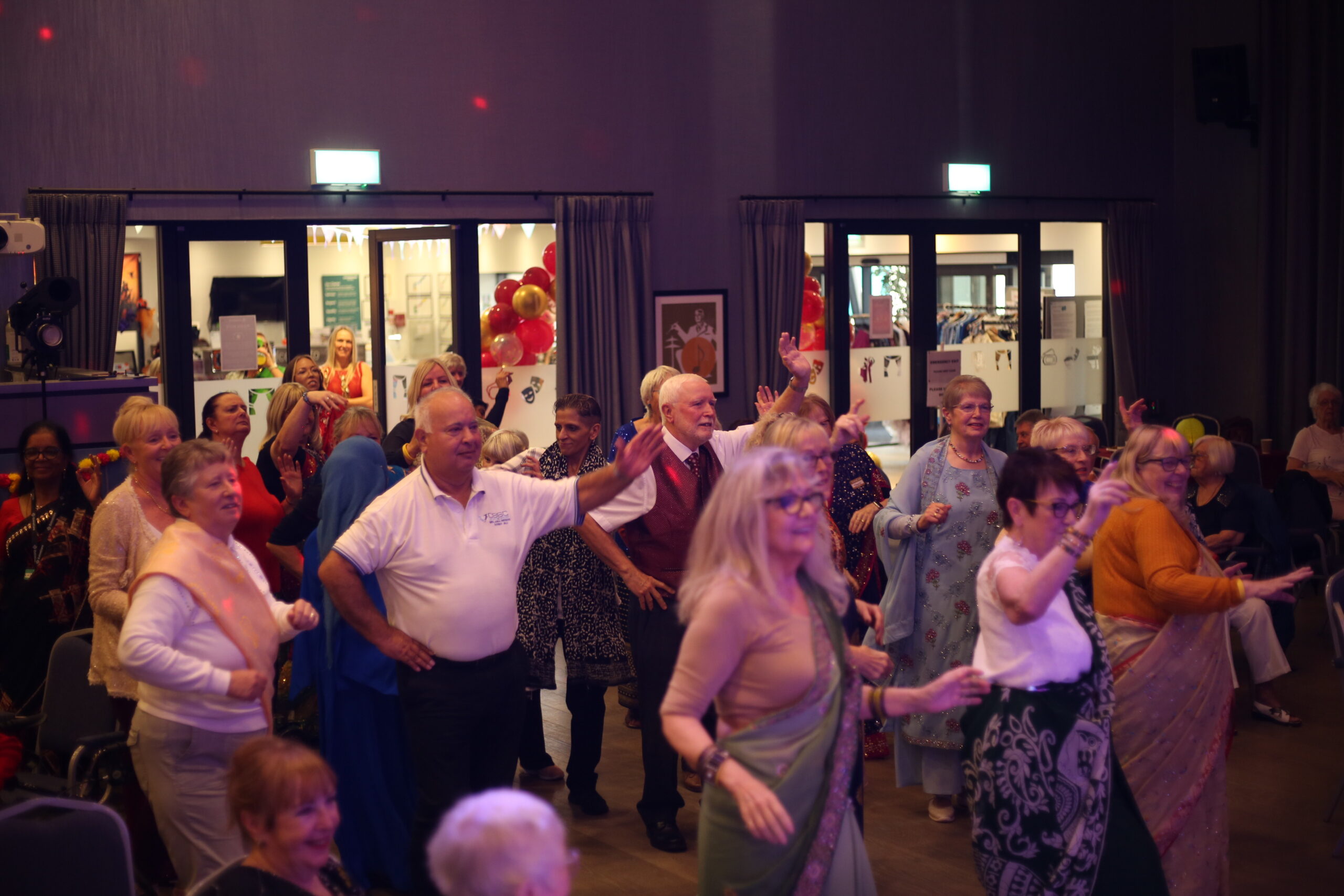 Group of residents dancing in a hall.