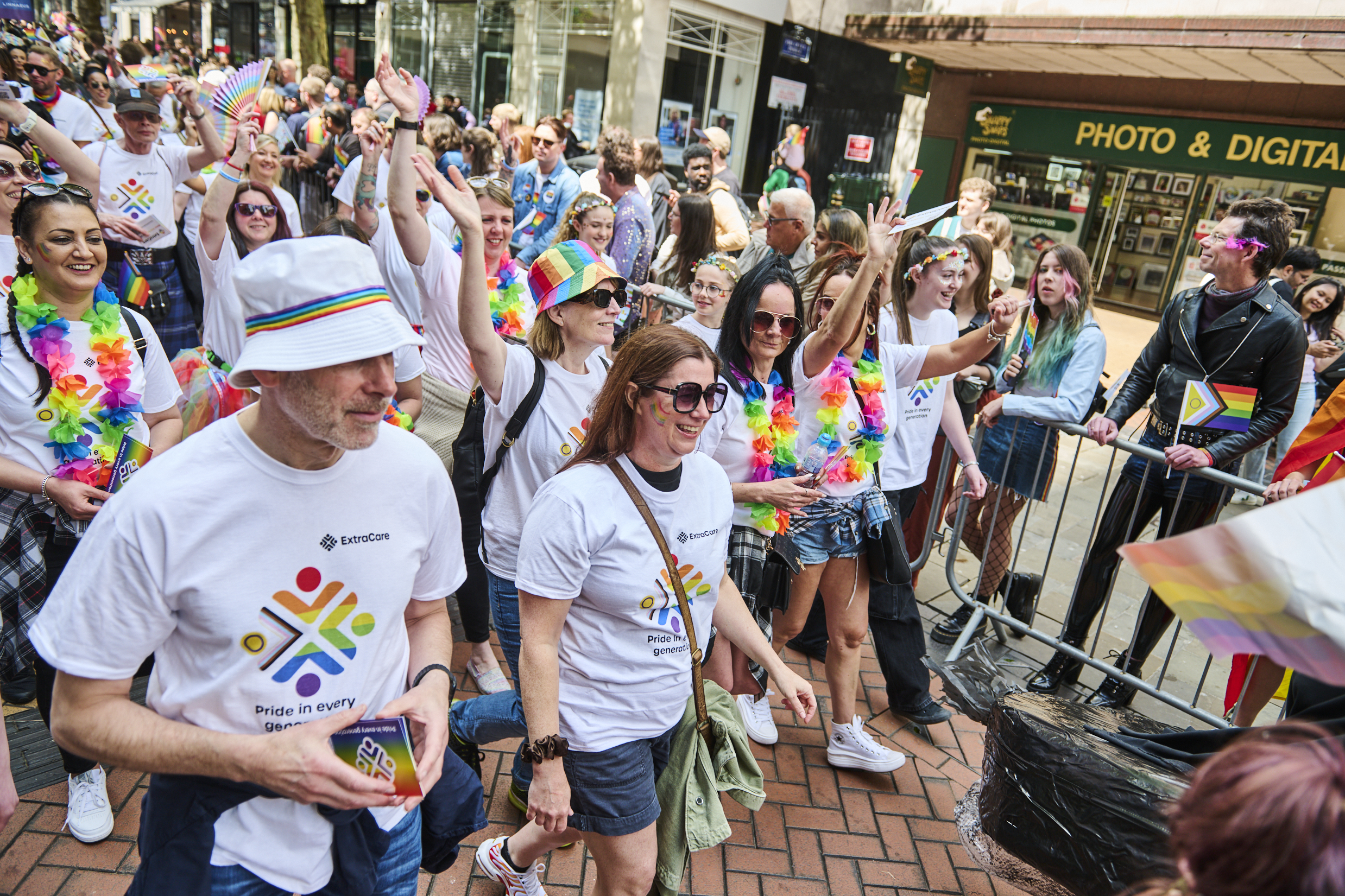 The group walking through the city in matching tshirts for Pride.