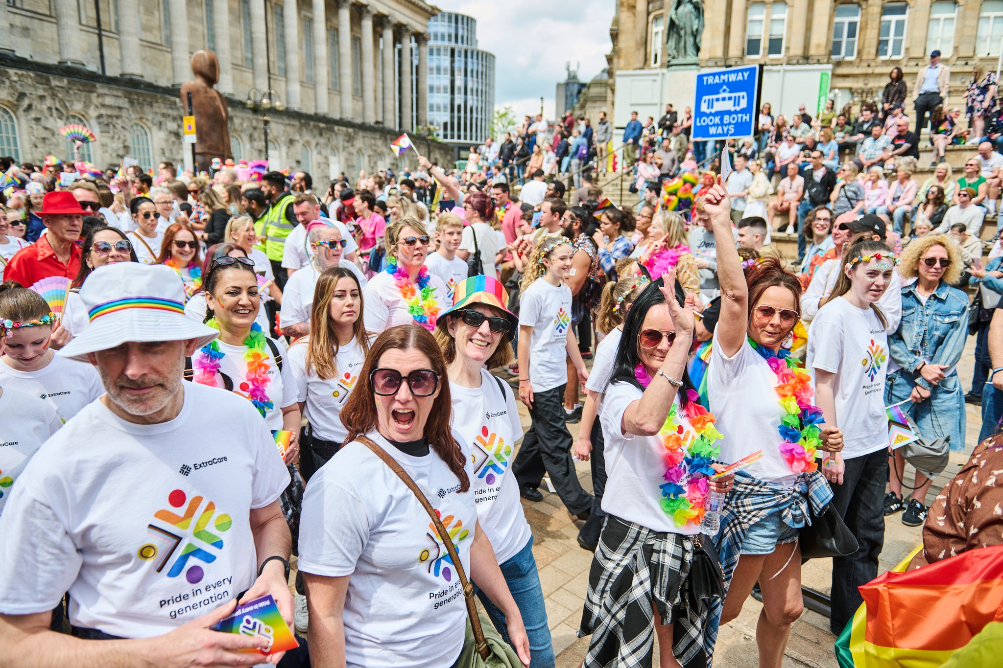 A big group in Birmingham Pride dressed in ExtraCare emblazoned t-shirts.