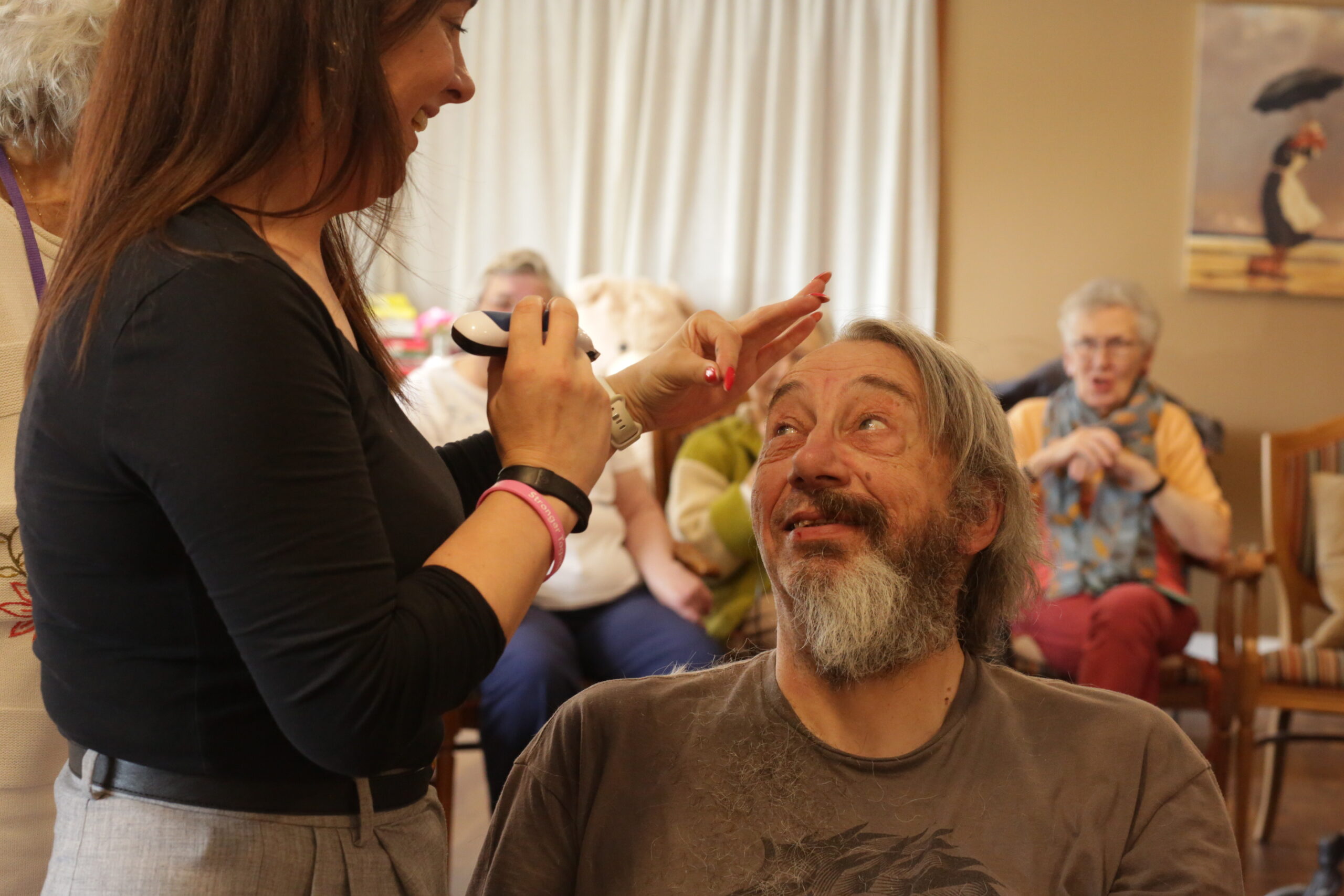 A staff member shaving Gary's eyebrows.