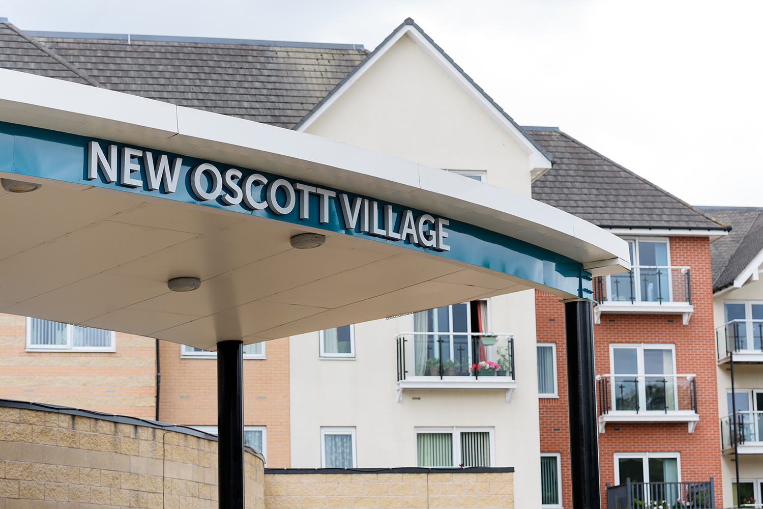 The sign saying New Oscott Village on top of the building entrace