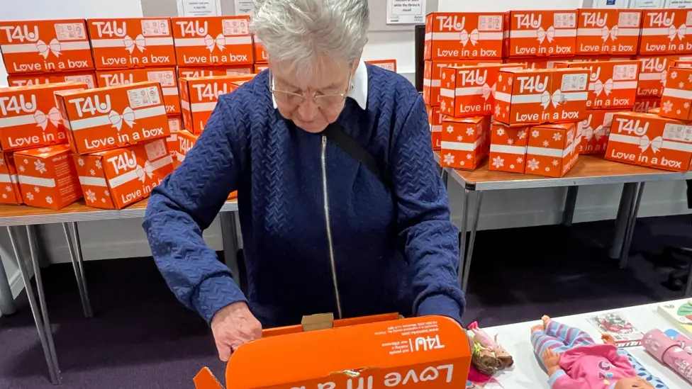 A resident fills a box.